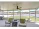 Spacious screened-in patio with seating and backyard view at 445 Arch Ridge Loop, Seffner, FL 33584