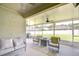 Screened-in patio with ceiling fans and outdoor seating at 445 Arch Ridge Loop, Seffner, FL 33584