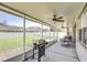 Covered patio with outdoor kitchen and multiple seating areas at 445 Arch Ridge Loop, Seffner, FL 33584