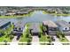 Aerial view of homes surrounding a serene lake, showcasing community layout and waterfront properties at 4652 San Martino Dr, Wesley Chapel, FL 33543