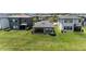 Aerial view of large backyard with lush green lawn and covered patio at 4652 San Martino Dr, Wesley Chapel, FL 33543
