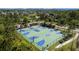 Aerial view of a colorful, well-maintained basketball and volleyball court in a lush community setting at 4652 San Martino Dr, Wesley Chapel, FL 33543