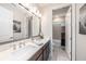 Bright bathroom features double vanity sinks with modern fixtures and a tiled shower/tub combo at 4652 San Martino Dr, Wesley Chapel, FL 33543