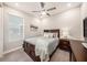 Comfortable bedroom with neutral walls, soft carpet, and a large window with blinds for natural light at 4652 San Martino Dr, Wesley Chapel, FL 33543