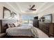 A spacious main bedroom features a ceiling fan, a lake view, and ample closet space at 4652 San Martino Dr, Wesley Chapel, FL 33543