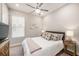 Cozy bedroom features a ceiling fan and a comfortable bed with side tables and decorative lamps at 4652 San Martino Dr, Wesley Chapel, FL 33543