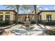 Elegant clubhouse featuring beautiful fountain, lush landscaping, and charming architecture at 4652 San Martino Dr, Wesley Chapel, FL 33543