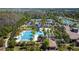 Community aerial view highlighting a stunning pool with palm trees, a clubhouse and recreation area at 4652 San Martino Dr, Wesley Chapel, FL 33543