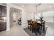 Bright dining area with an elegant chandelier, six-seat table, and seamless access to other areas at 4652 San Martino Dr, Wesley Chapel, FL 33543