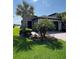 Charming single-story home with well-manicured lawn and lush landscaping, including palm trees at 4652 San Martino Dr, Wesley Chapel, FL 33543