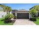 Beautiful home features a brick driveway, a two-car garage, and manicured landscaping at 4652 San Martino Dr, Wesley Chapel, FL 33543