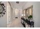 Hallway view with elegant decor, a mirror, and multiple doorways under recessed lights at 4652 San Martino Dr, Wesley Chapel, FL 33543
