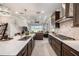 Modern kitchen with stainless steel appliances, an island with bar seating, and an adjacent Gathering room at 4652 San Martino Dr, Wesley Chapel, FL 33543