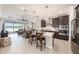 Open concept kitchen with center island and stainless steel appliances seamlessly connects to the living area at 4652 San Martino Dr, Wesley Chapel, FL 33543