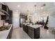 Spacious kitchen featuring stainless steel appliances, an island with sink and access to the dining area at 4652 San Martino Dr, Wesley Chapel, FL 33543
