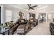 Open-concept living room with tile flooring and seamlessly connected to the kitchen and dining area at 4652 San Martino Dr, Wesley Chapel, FL 33543