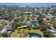 Wide aerial view of house by pond and near ocean in a beautiful residential neighborhood at 4702 W Heron Ln, Tampa, FL 33629