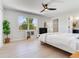 White bedroom features a ceiling fan, large window with a view, plus access to the closet at 4702 W Heron Ln, Tampa, FL 33629