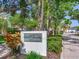 Beautiful Audubon Park community sign surrounded by lush landscaping and mature trees at 4702 W Heron Ln, Tampa, FL 33629