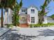 Charming two-story home with landscaped yard and inviting entryway, complemented by tropical landscaping at 4702 W Heron Ln, Tampa, FL 33629