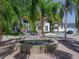 Stunning fountain situated among palm trees highlighting the beauty of the home's curb appeal at 4702 W Heron Ln, Tampa, FL 33629