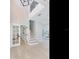 Bright foyer featuring hardwood floors, white trim and doors, plus a staircase leading to the second floor at 4702 W Heron Ln, Tampa, FL 33629
