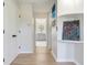 Bright hallway showcases modern artwork and leads to a bathroom with elegant finishes and fixtures at 4702 W Heron Ln, Tampa, FL 33629