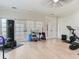 Well-equipped home gym space featuring light hardwood floors and ample room for exercise equipment at 4702 W Heron Ln, Tampa, FL 33629