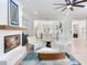 Open-concept living room featuring a fireplace and modern furniture at 4702 W Heron Ln, Tampa, FL 33629