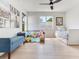 Bright playroom with hardwood floors, plenty of natural light, a daybed and blue bench at 4702 W Heron Ln, Tampa, FL 33629