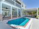 Backyard pool with a brick patio and steps, plus a covered patio area and a second story deck at 4702 W Heron Ln, Tampa, FL 33629