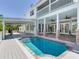 Backyard pool with covered patio area, a grill, and a second story deck overlooking the yard at 4702 W Heron Ln, Tampa, FL 33629