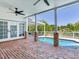 Backyard pool with brick patio, a covered pergola area, and a white fence surrounding the property at 4702 W Heron Ln, Tampa, FL 33629