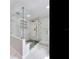 Modern shower featuring marble walls, glass doors, and a built-in shelf for storage at 4702 W Heron Ln, Tampa, FL 33629