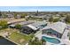 Aerial view of waterfront home with screened patio, pool, and canal access at 5051 Bonito Dr, New Port Richey, FL 34652