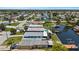 Aerial view of waterfront homes with canal access, pool, and docks for boating at 5051 Bonito Dr, New Port Richey, FL 34652