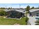 Spacious backyard boasts a screened patio with ample seating and golf cart storage, ideal for relaxation and convenience at 5051 Bonito Dr, New Port Richey, FL 34652