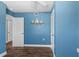 A secondary bedroom features crisp white trim and baseboards, along with wood-look vinyl flooring at 5051 Bonito Dr, New Port Richey, FL 34652