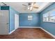 Bedroom with hardwood floors and a ceiling fan has lots of closet space at 5051 Bonito Dr, New Port Richey, FL 34652