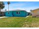 This colorful house includes a well kept lawn and walkway, offering a cheerful welcome at 5051 Bonito Dr, New Port Richey, FL 34652