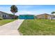 Charming home boasts a well-manicured lawn and a welcoming driveway, perfect for curb appeal at 5051 Bonito Dr, New Port Richey, FL 34652