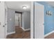 Hallway leading to in-unit laundry with a stacked washer and dryer at 5051 Bonito Dr, New Port Richey, FL 34652