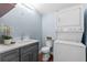Cozy laundry room features a stacked washer and dryer with a vanity and sink at 5051 Bonito Dr, New Port Richey, FL 34652
