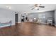Spacious living area with stylish seating, warm wood-look floors, and a convenient kitchen view at 5051 Bonito Dr, New Port Richey, FL 34652