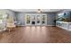 Inviting living room featuring wood-look floors and sliding doors that lead to a scenic outdoor view at 5051 Bonito Dr, New Port Richey, FL 34652