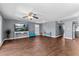Open floor plan with living area featuring a TV, and access to the kitchen at 5051 Bonito Dr, New Port Richey, FL 34652