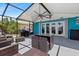 Well appointed outdoor patio includes a grill, a ceiling fan, and comfortable wicker furniture at 5051 Bonito Dr, New Port Richey, FL 34652