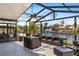 Screened patio with wicker furniture, ceiling fan, and waterfront views for ultimate relaxation at 5051 Bonito Dr, New Port Richey, FL 34652