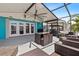 Covered patio with ceiling fan, wicker furniture, and bright blue accents for outdoor enjoyment at 5051 Bonito Dr, New Port Richey, FL 34652