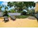 Well-maintained backyard with patio seating area, lush landscaping, and privacy fencing at 509 Stone Dr, Brandon, FL 33510